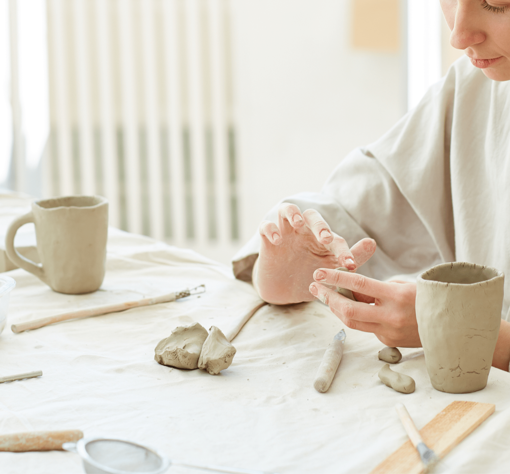 Woman uses a DIY Pottery Kit to Build Ceramic Mugs