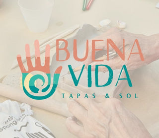 Logo of 'BUENA VIDA Tapas & Sol' with hands holding a pottery tools, blurred background.