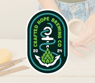 Crafted Hope Brewing Co logo with hands holding a pinch pot on a light background
