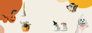 A hand holds a carved white ceramic pumpkin candle on the left, with three more ghost-shaped candles in Halloween styles on a stylized orange and cream background.