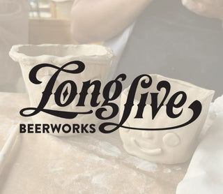 Decorative pillow with 'Longlive Beerworks' text on a blurred background