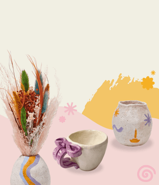 Collection of ceramic items including mugs, vases, and decorative pieces on a light background.
