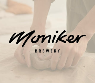 Person holding pottery with 'Moniker Brewery' logo overlay