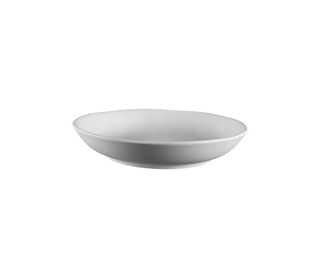 A minimalist white ceramic bowl with a shallow, wide rim, shown from a side angle against a solid white background.