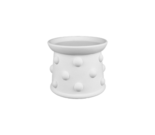 A white ceramic or stoneware candle holder with a flared rim and a textured body covered in raised polka dots, shown on a plain white background.