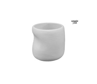 A small white ceramic cup with a textured matte finish and a slightly tapered, organic shape, shown on a plain white background with the brand name 'amnie y'all' printed in black in the upper right.