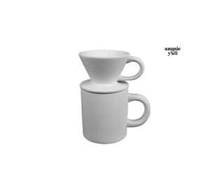 A white ceramic pour-over coffee set consisting of a cone-shaped dripper and a matching mug, shown on a plain white background with the text 'amnie y'all' in the upper right.