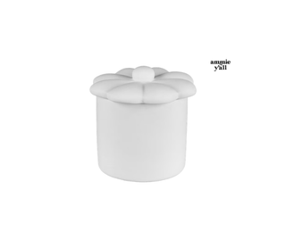 A white cylindrical ottoman or stool with a flower-shaped padded top, shown on a plain white background. Small text in the upper right reads 'amnie y'all'.