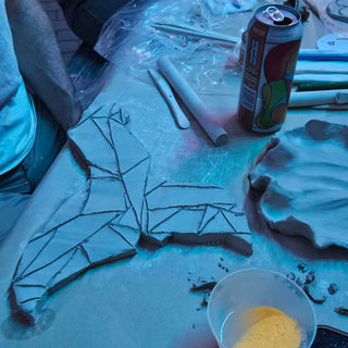 Person working on a mosaic art project