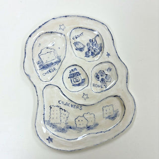 Decorative ceramic plate with blue designs on a white background