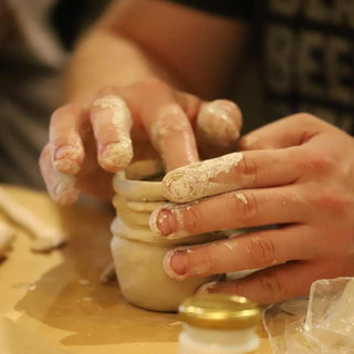 Close-up of hands working with clay