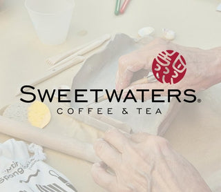 Person making pttery cup with Sweetwaters Coffee & Tea logo in the foreground
