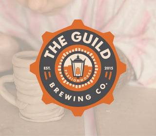 The Guild Brewing Co. logo with a blurred mug in the background