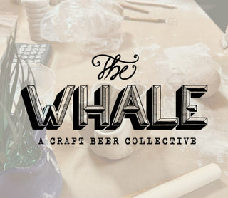 Logo of 'The Whale' craft beer collective with decorative elements.