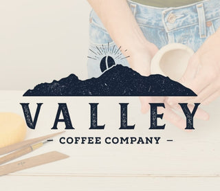 Valley Coffee Company logo with hands holding pottery on a light background