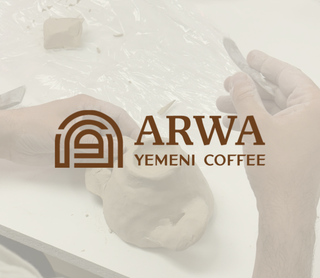 A sepia-toned workshop scene showing hands working with clay, overlaid with the brown logo and text 'ARWA YEMENI COFFEE'.