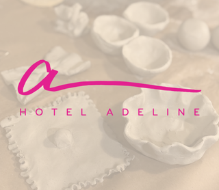 A soft, sepia-toned scene showing white clay objects arranged on a surface, with a large pink script logo reading 'a' and the words 'HOTEL ADELINE' across the center.