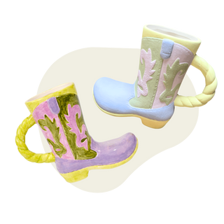 Colorful cowboy boot-shaped mugs on a white background