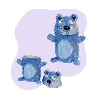Set of blue bear-shaped containers on a light purple background