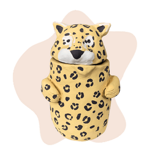 Leopard-shaped cookie jar on a green background
